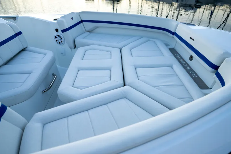Slide: The Image of Luxurious seating area on the 2026 Wellcraft 28 Explorer boat, featuring sleek white upholstery. - 7