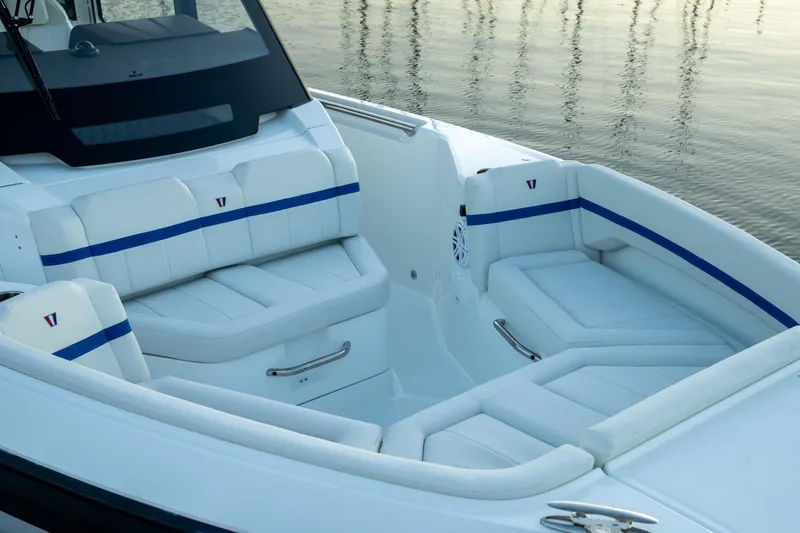 Slide: The Image of 2026 Wellcraft 28 Explorer boat interior with white seating and blue accents. - 8
