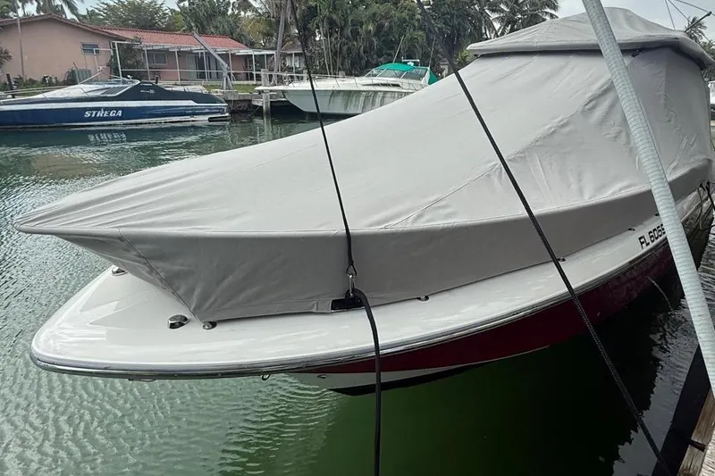 Slide: The Image of 2010 Triton 351 Express boat interior with helm, rod holders, and electronics. - 11