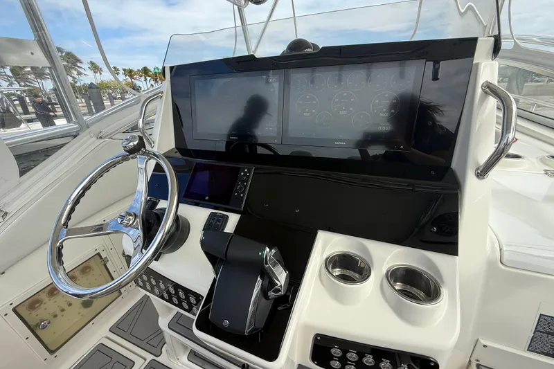 Slide: The Image of Helm of 2010 Triton 351 Express boat with modern controls and navigation display. - 14