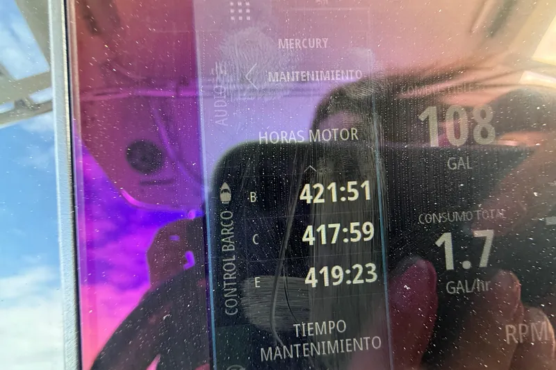 Slide: The Image of Close-up of a Triton 351 Express 2010 boat dashboard displaying engine hours and fuel consumption. - 15