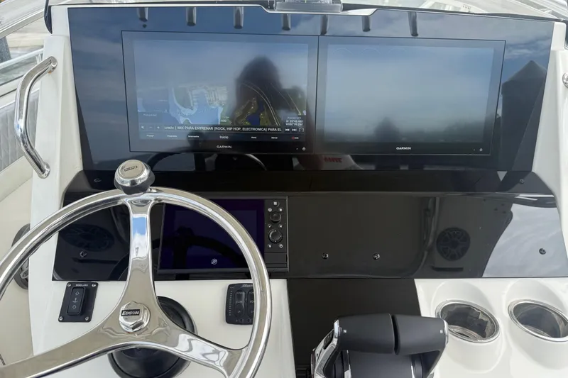 Slide: The Image of Control panel of 2010 Triton 351 Express boat with dual Garmin displays. - 17