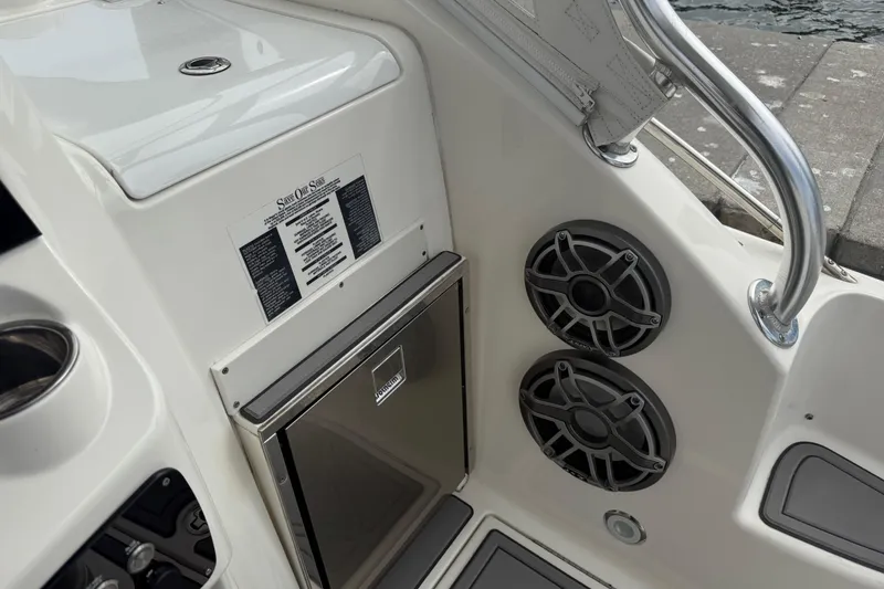 Slide: The Image of 2010 Triton 351 Express boat interior with speakers and storage compartment. - 19