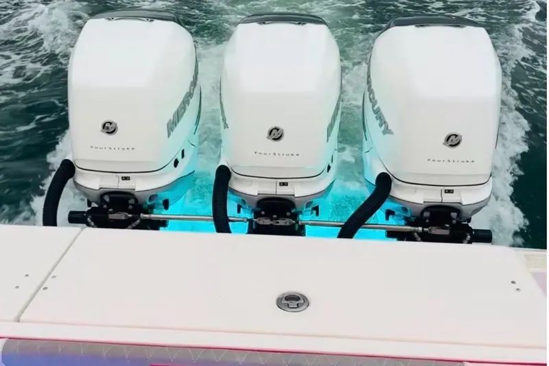 Slide: The Image of 2010 Triton 351 Express boat docked at a marina with modern buildings. - 2