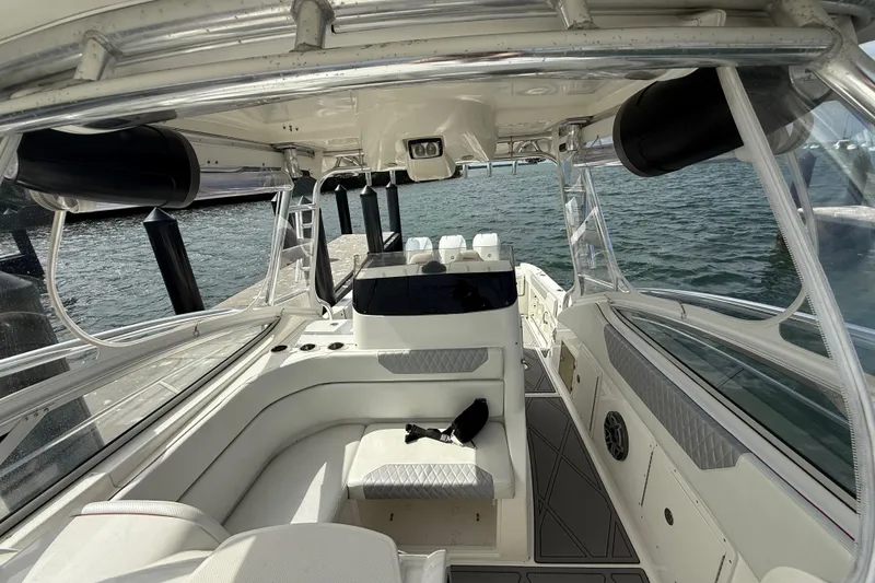 Slide: The Image of 2010 Triton 351 Express boat interior with seating, helm, and ocean view. - 25