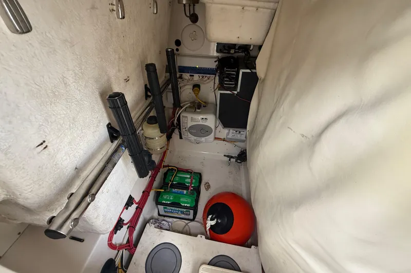 Slide: The Image of 2010 Triton 351 Express boat interior with equipment and storage area. - 26