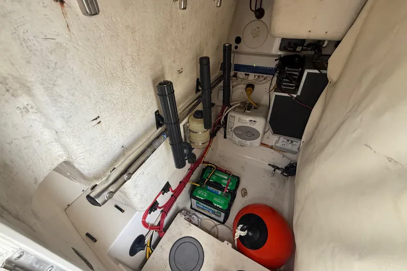 Slide: The Image of Interior of a 2010 Triton 351 Express boat showing equipment and storage area. - 27
