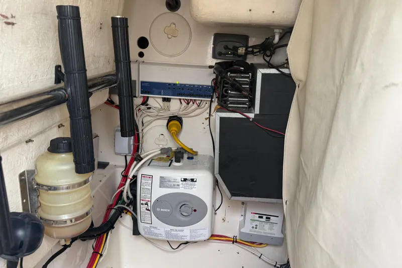 Slide: The Image of 2010 Triton 351 Express boat interior showing electrical and mechanical components. - 28