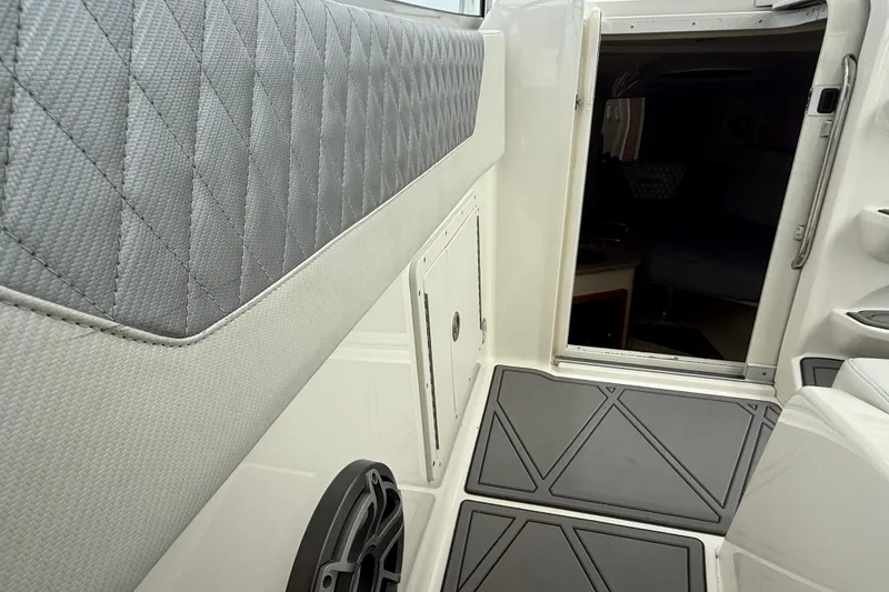 Slide: The Image of Interior view of 2010 Triton 351 Express boat, featuring quilted upholstery and open cabin door. - 30