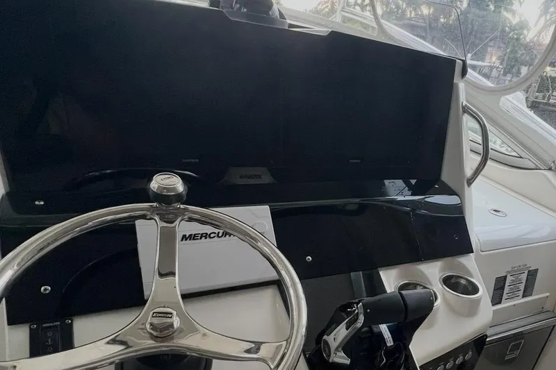 Slide: The Image of 2010 Triton 351 Express boat docked with triple 400 horsepower engines. - 4