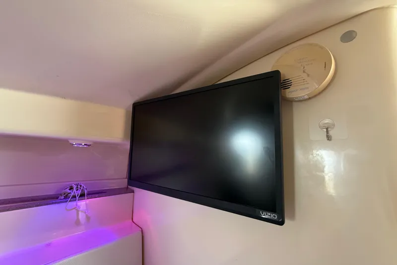 Slide: The Image of Interior of 2010 Triton 351 Express with wall-mounted Vizio TV and smoke detector. - 41