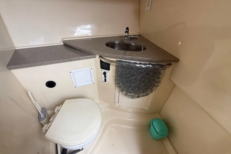 Slide: The Image of Compact bathroom in 2010 Triton 351 Express boat with sink and toilet. - 43