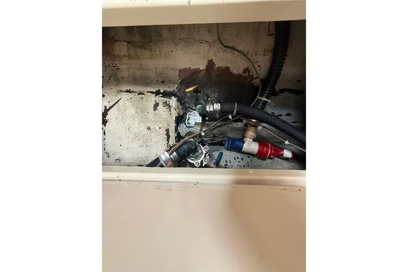 Slide: The Image of Bilge area of 2010 Triton 351 Express boat showing hoses and fittings. - 45