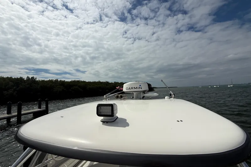 Slide: The Image of Triton 351 Express 2010 boat with Garmin radar on open water under cloudy sky. - 48