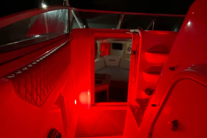 Slide: The Image of 2010 Triton 351 Express boat with triple Mercury outboard engines docked by the water. - 5