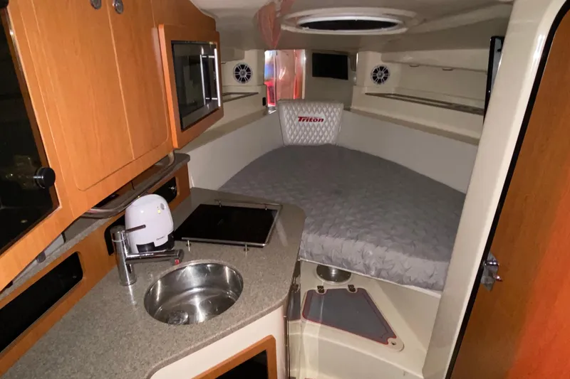 Slide: The Image of 2010 Triton 351 Express boat with triple Mercury outboard engines at dock. - 6