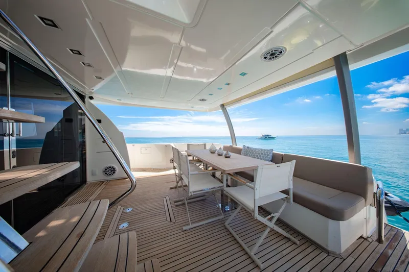 Slide: The Image of Luxurious 2015 Prestige 750 yacht deck with dining area overlooking serene ocean view. - 19