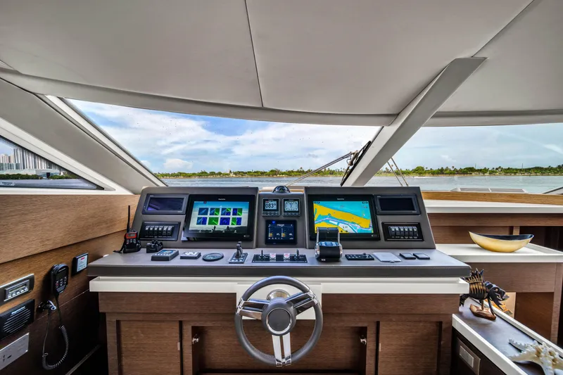 Slide: The Image of Cockpit of 2015 Prestige 750 yacht with navigation screens and steering wheel. - 33