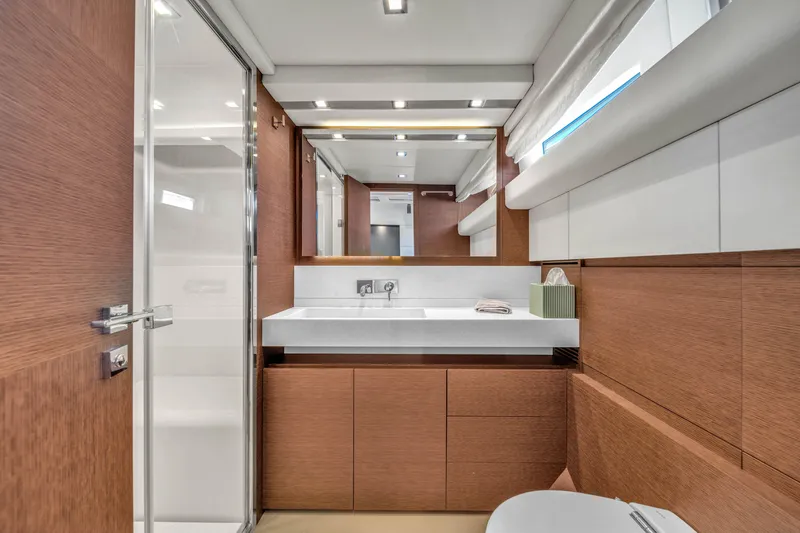 Slide: The Image of Luxurious bathroom interior of 2015 Prestige 750 yacht with modern fixtures and wood accents. - 41