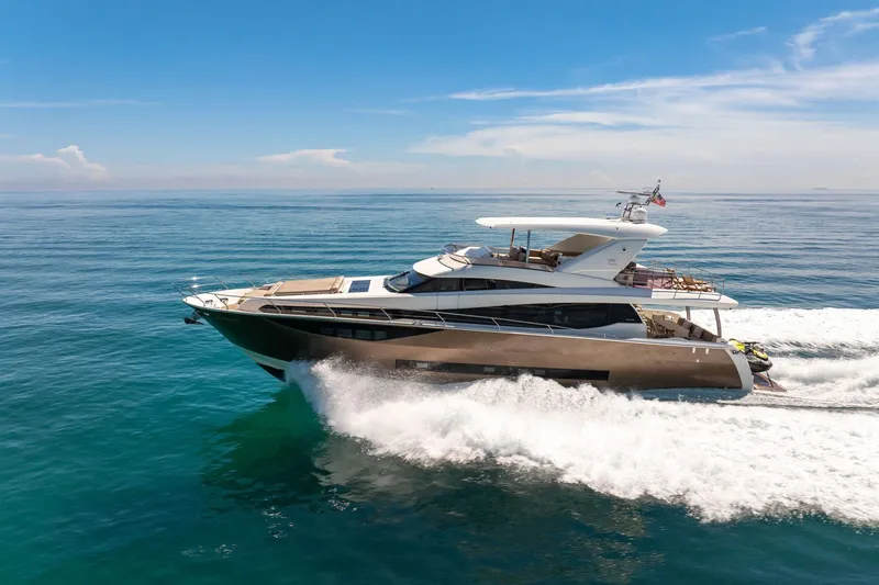 Slide: The Image of Luxury 2015 Prestige 750 yacht cruising on open sea under clear blue sky. - 76