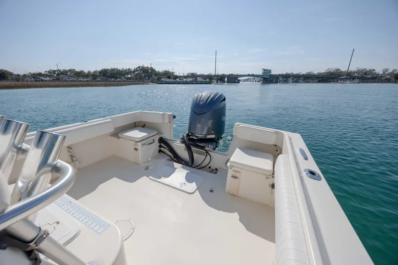 Slide: The Image of 2007 Parker 2300 Special Edition boat on calm water, featuring an outboard motor. - 10