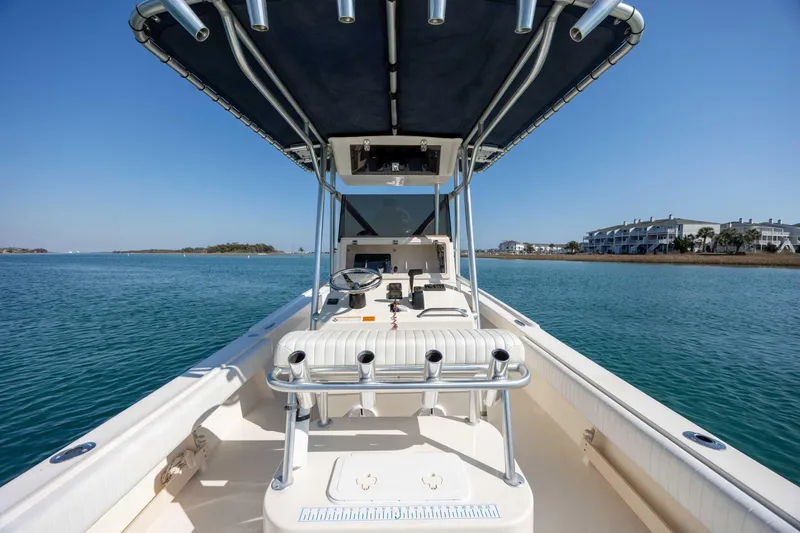Slide: The Image of 2007 Parker 2300 Special Edition boat on calm water, clear sky, coastal view. - 13