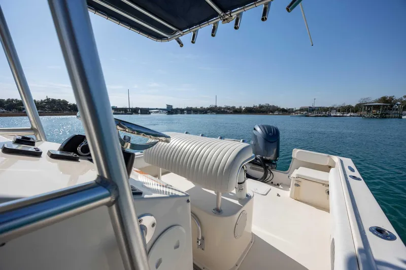 Slide: The Image of 2007 Parker 2300 Special Edition boat on calm water, featuring a sleek interior and outboard motor. - 15
