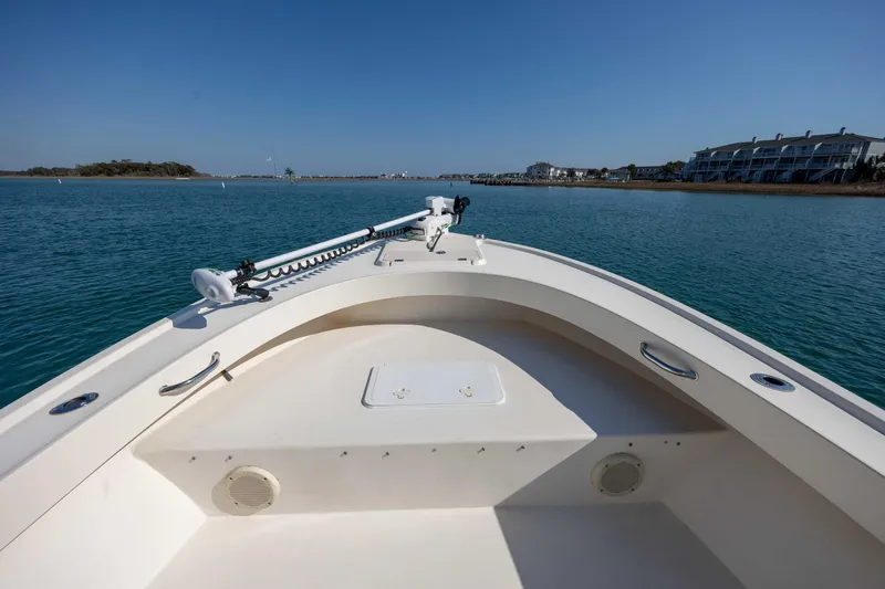 Slide: The Image of 2007 Parker 2300 Special Edition boat on calm water, with coastal buildings in the background. - 16