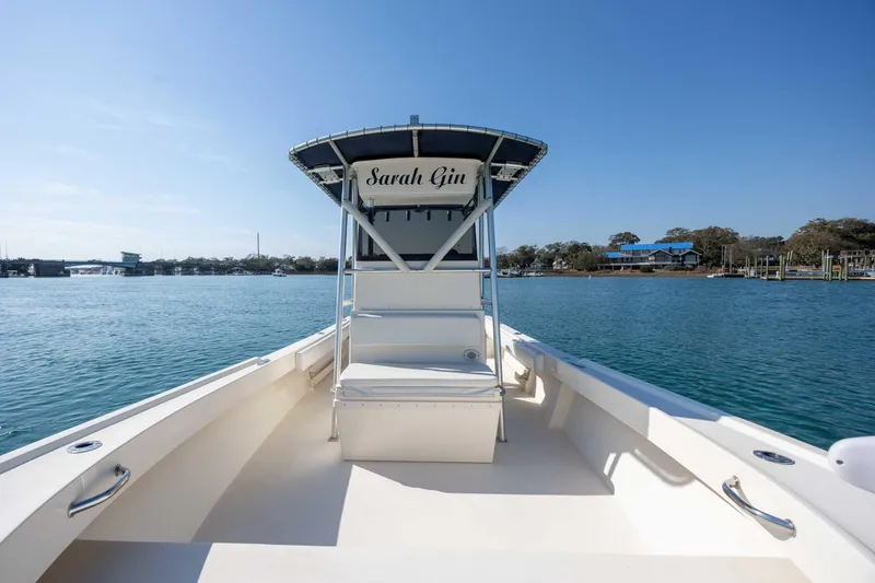 Slide: The Image of 2007 Parker 2300 Special Edition boat on calm water, clear sky, and scenic shoreline. - 17