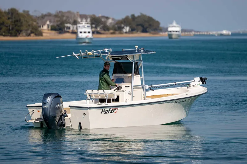 Slide: The Image of 2007 Parker 2300 Special Edition boat on calm water with scenic background. - 5