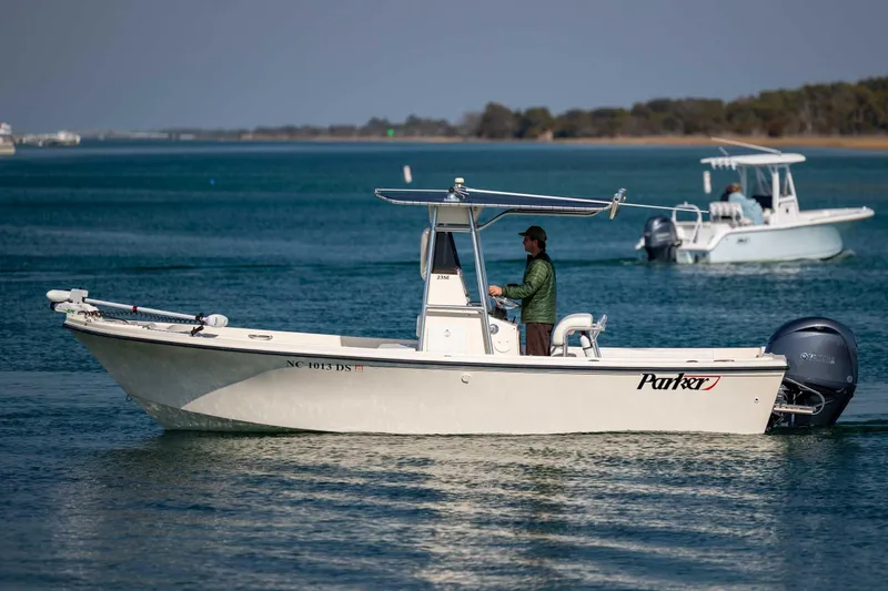 Slide: The Image of 2007 Parker 2300 Special Edition boat cruising on calm blue waters. - 8
