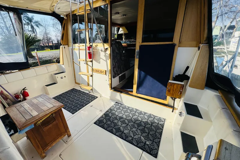 Slide: The Image of 1990 Bayliner 3888 Motoryacht interior with wooden accents and nautical decor. - 19