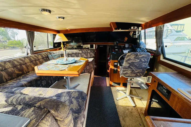 Slide: The Image of 1990 Bayliner 3888 Motoryacht interior with dining area and helm station. - 20