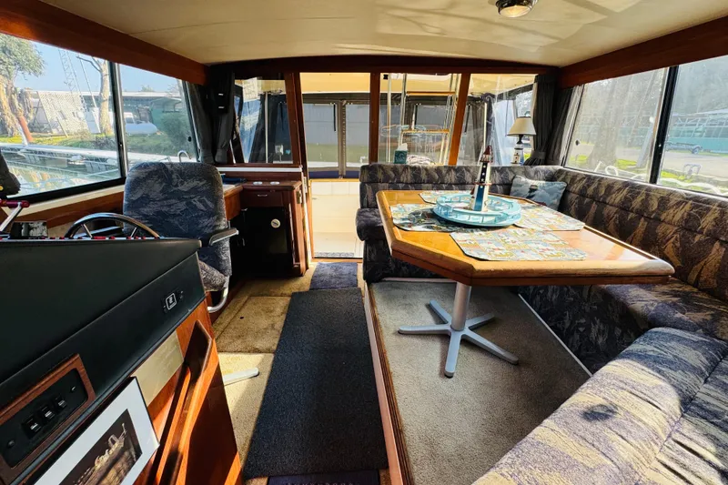 Slide: The Image of 1990 Bayliner 3888 Motoryacht interior with dining area and helm station. - 23