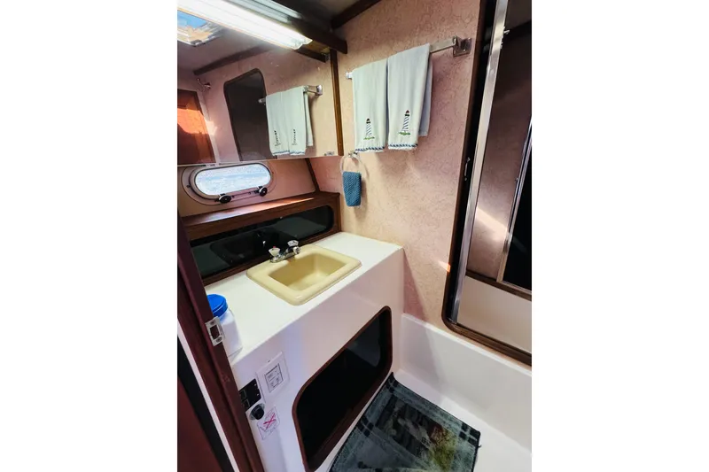 Slide: The Image of 1990 Bayliner 3888 Motoryacht bathroom with sink, mirror, and towels. - 33