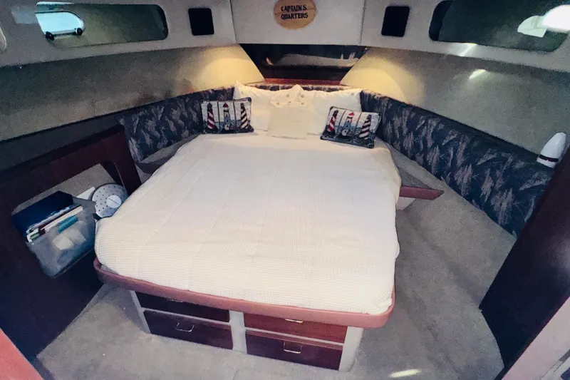 Slide: The Image of 1990 Bayliner 3888 Motoryacht cabin with cozy bed and nautical decor. - 35