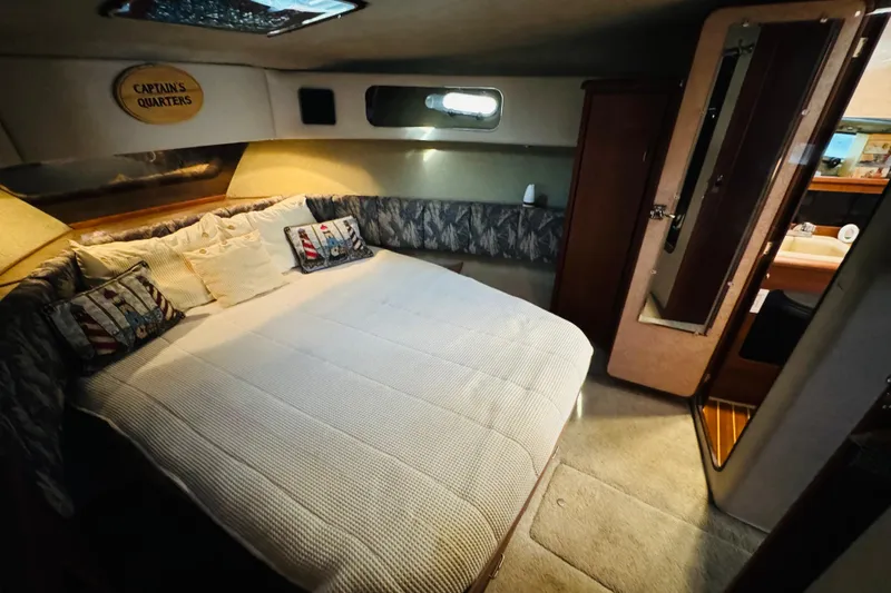 Slide: The Image of Cozy cabin interior of 1990 Bayliner 3888 Motoryacht with bed and nautical decor. - 37