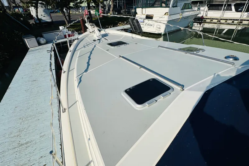 Slide: The Image of 1990 Bayliner 3888 Motoryacht docked, showcasing spacious deck and sleek design. - 9