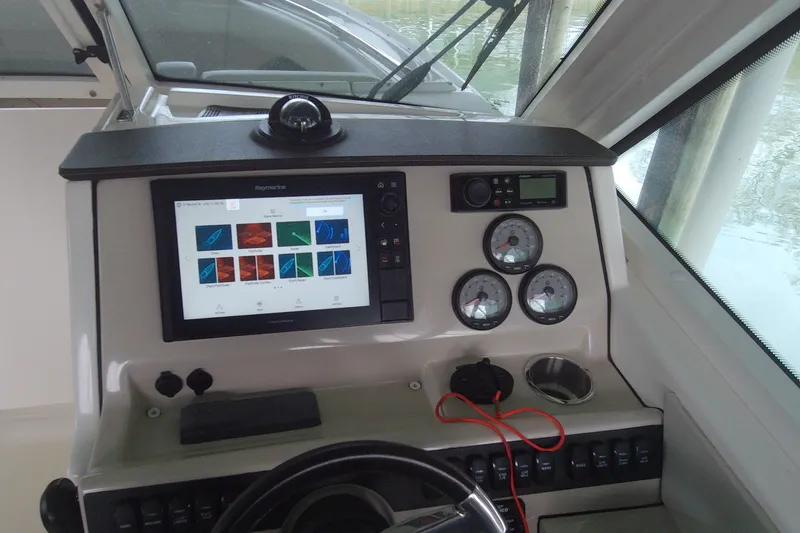 Slide: The Image of Control panel of a 2021 Boston Whaler 280 Vantage boat with navigation display. - 11