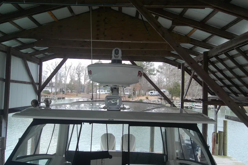 Slide: The Image of 2021 Boston Whaler 280 Vantage docked under a wooden boathouse. - 17