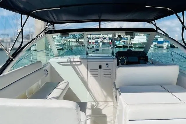 Slide: The Image of 2003 Tiara Yachts 2900 Coronet on dry dock, sleek black hull, sunny day. - 15