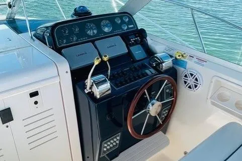 Slide: The Image of 2003 Tiara Yachts 2900 Coronet cockpit with white seating and storage compartments. - 18