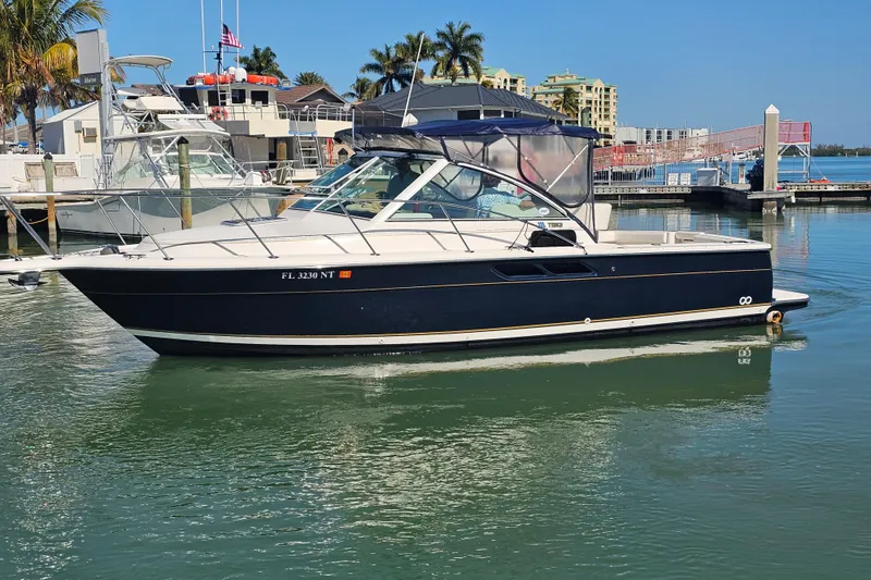 Slide: The Image of 2003 Tiara Yachts 2900 Coronet in marina, sleek design, blue hull, sunny day. - 2