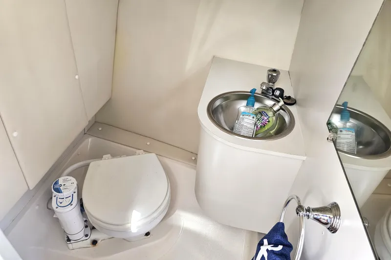 Slide: The Image of 2003 Tiara Yachts 2900 Coronet bathroom with toilet, sink, and mirror. - 31