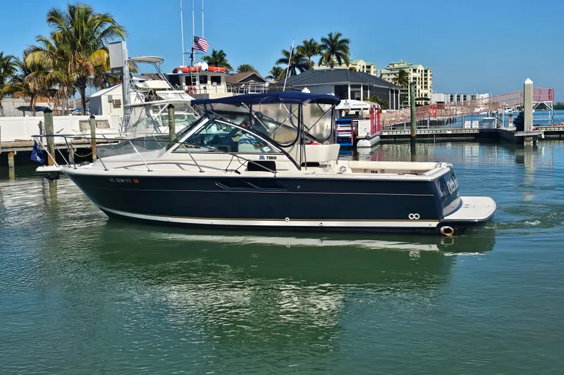 Slide: The Image of 2003 Tiara Yachts 2900 Coronet docked in a sunny marina setting. - 4