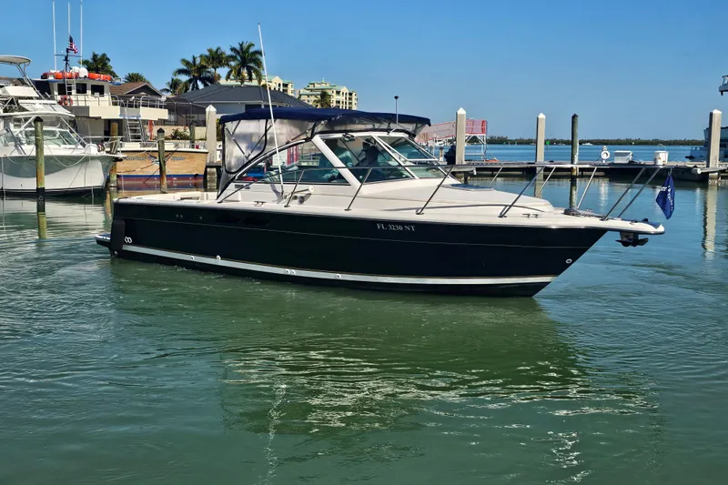 Slide: The Image of 2003 Tiara Yachts 2900 Coronet docked in a marina under clear blue skies. - 7