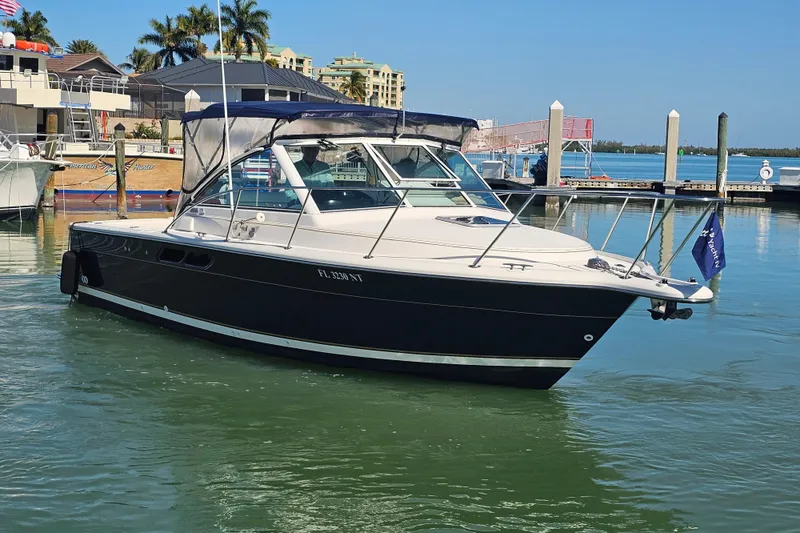 Slide: The Image of 2003 Tiara Yachts 2900 Coronet docked at marina, sunny day, calm waters. - 8