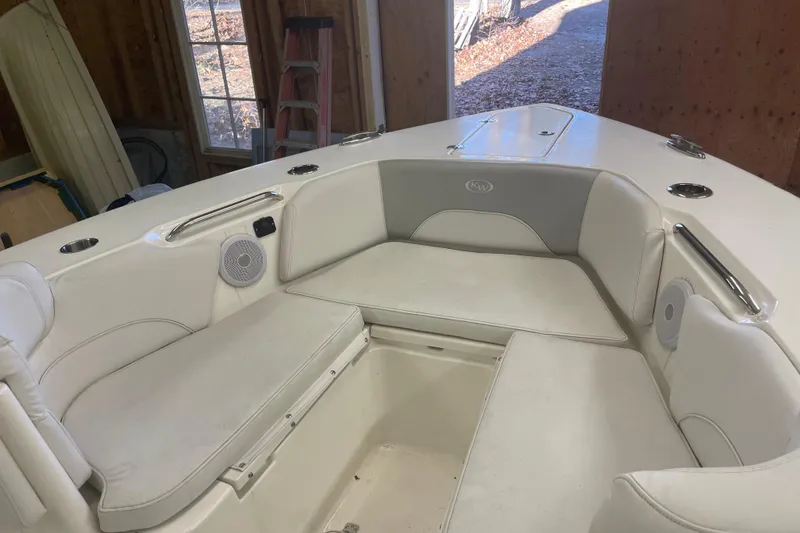 Slide: The Image of 2023 Key West 263 FS boat interior with cushioned seating and built-in speakers. - 19