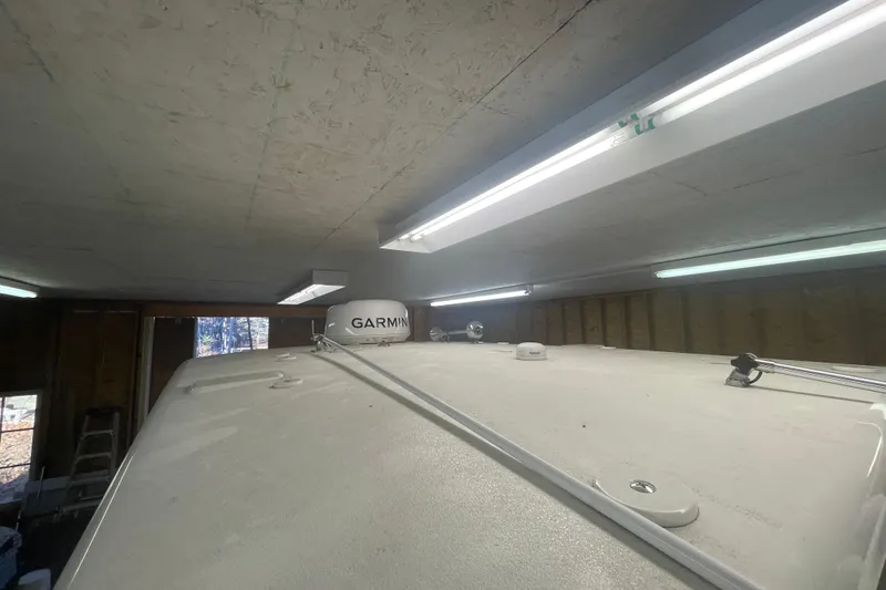 Slide: The Image of 2023 Key West 263 FS boat roof with Garmin equipment in a garage. - 27