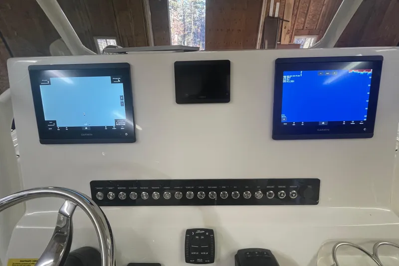 Slide: The Image of 2023 Key West 263 FS boat dashboard with dual Garmin displays and control panel. - 28
